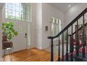 Elegant foyer with hardwood floors, a grand staircase, and a bright, welcoming atmosphere at 4601 Fairhope Dr, Indianapolis, IN 46237