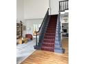 Open foyer with a beautiful staircase and views into the living and dining areas at 4601 Fairhope Dr, Indianapolis, IN 46237