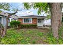 Charming single-story home featuring a brick facade and a well-maintained front yard at 4956 W 11Th St, Speedway, IN 46224