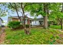 Charming single-story home featuring a brick facade and a well-maintained front yard at 4956 W 11Th St, Speedway, IN 46224