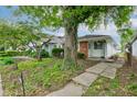 Charming single-story home featuring a brick facade and a well-maintained front yard at 4956 W 11Th St, Speedway, IN 46224
