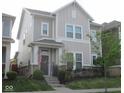 Charming two-story home with inviting front porch and well-manicured lawn exudes curb appeal at 5755 Buskirk Dr, Indianapolis, IN 46216