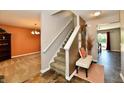 Inviting foyer with staircase, bench, and views into the living spaces at 5827 High Grass Ln, Indianapolis, IN 46235