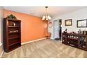 Spacious living room with a neutral color scheme, bookshelf, and stylish light fixture at 5827 High Grass Ln, Indianapolis, IN 46235