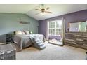 Cozy bedroom with a ceiling fan, large window, and comfortable furnishings at 6190 E Ayrshire Cir, Camby, IN 46113