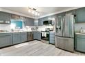 Modern kitchen featuring stainless steel appliances, gray cabinets, and stylish countertops at 6190 E Ayrshire Cir, Camby, IN 46113