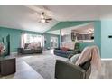 Bright living room with vaulted ceilings, stylish furnishings, and views into the modern kitchen at 6190 E Ayrshire Cir, Camby, IN 46113