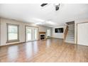 Bright living room featuring beautiful hardwood floors, a fireplace, and a staircase at 6354 Cotton Bay N Dr, Indianapolis, IN 46254