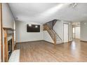 Spacious living room with hardwood floors, a fireplace, and stairway at 6354 Cotton Bay N Dr, Indianapolis, IN 46254