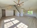Bright and spacious living room featuring vaulted ceilings, staircase, and modern flooring at 6369 Kelsey Dr, Indianapolis, IN 46268