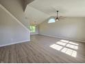 Bright and spacious living room featuring vaulted ceilings, large window, and modern flooring at 6369 Kelsey Dr, Indianapolis, IN 46268