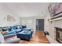 Bright living room boasts hardwood floors, a large fireplace, and comfortable blue furniture at 7606 Old Oakland Blvd E Dr, Indianapolis, IN 46236