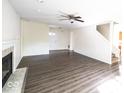 This living room features fresh paint, wood-look flooring and a fireplace at 7611 Misty Meadow Dr, Indianapolis, IN 46217