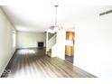 Bright living room includes wood-look flooring, fireplace, and updated light fixtures at 7611 Misty Meadow Dr, Indianapolis, IN 46217