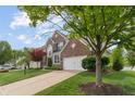 Charming two-story brick home with a well-manicured lawn and attached two car garage at 828 Breaside Ln, Greenwood, IN 46143