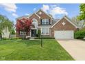 Charming two-story brick home with a well-manicured lawn and attached two car garage at 828 Breaside Ln, Greenwood, IN 46143