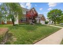 Charming two-story brick home with a well-manicured lawn and attached two car garage at 828 Breaside Ln, Greenwood, IN 46143