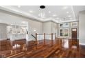 Spacious living room with hardwood floors, a modern chandelier, and natural light streaming through large windows at 888 Westcreek Dr, Columbus, IN 47201
