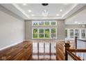 Bright and airy living room featuring hardwood floors, large windows, and elegant recessed lighting fixtures at 888 Westcreek Dr, Columbus, IN 47201