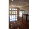 Open-concept living room features hardwood floors, large windows, and decorative lighting at 888 Westcreek Dr, Columbus, IN 47201