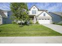 Traditional home boasting a spacious lawn, attached two car garage and inviting front porch at 9822 Tampico Chase, Fishers, IN 46040