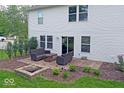 Charming backyard patio with outdoor seating and a brick fire pit, perfect for entertaining at 10316 Hatherley Way, Fishers, IN 46037