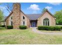 Charming home with blue front door, stone accents and well-kept lawn at 10602 Fall Rd, Fishers, IN 46037