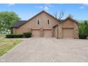 Spacious three-car garage with matching exterior and driveway at 10602 Fall Rd, Fishers, IN 46037