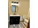 Modern bathroom featuring a black vanity, sleek faucet, and updated toilet at 1081 Torino Ln, Franklin, IN 46131