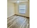 This bedroom has neutral walls, laminate flooring, a window with blinds, and electrical outlets at 1081 Torino Ln, Franklin, IN 46131