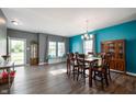 Bright dining area with hardwood floors, large windows, built-in bench, and stylish decor at 1257 Rosemary Ct, Greenfield, IN 46140