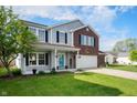 Well-maintained two-story home with blue shutters and a manicured lawn on a sunny day at 1257 Rosemary Ct, Greenfield, IN 46140