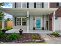 Inviting covered front porch with stylish decor, planters, and a 'Welcome' sign at 1257 Rosemary Ct, Greenfield, IN 46140
