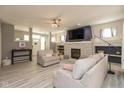 Bright living room with a stone fireplace, a large TV, and comfortable seating, perfect for Gathering gatherings at 1274 Old Heritage Pl, Greenwood, IN 46143