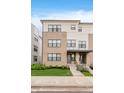 Modern townhouse with a combination brick and siding exterior and manicured lawn at 12990 Moultrie St, Carmel, IN 46032