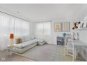 Bright living room with white walls, neutral furniture and light wood style flooring at 12990 Moultrie St, Carmel, IN 46032