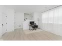 Modern office with light wood floors, white walls, and minimalist decor at 12990 Moultrie St, Carmel, IN 46032