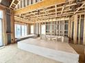Living room is under construction with a high ceiling, big windows, and drywall in the room at 1415 Beaumont Cir, Westfield, IN 46074
