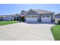 Wide driveway leading to a two-car garage on a single story home at 1472 Maple Ridge Ct, Columbus, IN 47201