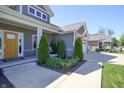 Charming front porch with cozy seating, stone accents, and beautifully landscaped surroundings at 1472 Maple Ridge Ct, Columbus, IN 47201