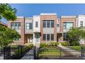 Attractive townhouse exteriors with brick and modern siding plus black metal fences add curb appeal at 1520 Central Ave, Indianapolis, IN 46202