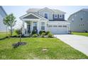 Charming two-story home with a manicured lawn and attached two-car garage at 15413 Staffordshire Way, Fishers, IN 46037