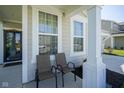 Cozy front porch featuring two chairs and ample natural light at 15413 Staffordshire Way, Fishers, IN 46037