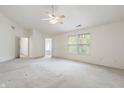 Bright main bedroom with carpet flooring and multiple windows offering natural light and attached bathroom at 16001 Concert Way, Noblesville, IN 46060
