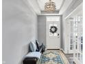 Inviting entryway featuring stylish decor, a cozy bench with accent pillows, and a decorative rug, setting a welcoming tone at 16516 Wilsons Farm Dr, Fishers, IN 46040