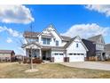 Charming two-story home boasts a manicured lawn, a welcoming porch, and a convenient two-car garage, ideal for Gathering living at 16516 Wilsons Farm Dr, Fishers, IN 46040