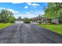 Well-maintained ranch style home with stone accents, a detached garage, and a long, paved driveway at 169 Bayview Dr, Cicero, IN 46034