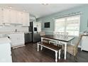 Eat-in kitchen with white cabinets, stainless steel appliances, and farmhouse-style dining set at 199 Three Notch Ln, Bargersville, IN 46106