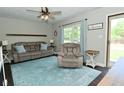 Cozy living room with neutral walls, light blue rug, ceiling fan and comfortable furniture at 199 Three Notch Ln, Bargersville, IN 46106