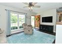 Bright living room with wood laminate flooring, TV, plush seating and view of front yard at 199 Three Notch Ln, Bargersville, IN 46106